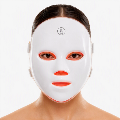 A white LED facial therapy mask worn by a model, shown from the chest up against a clean white background.